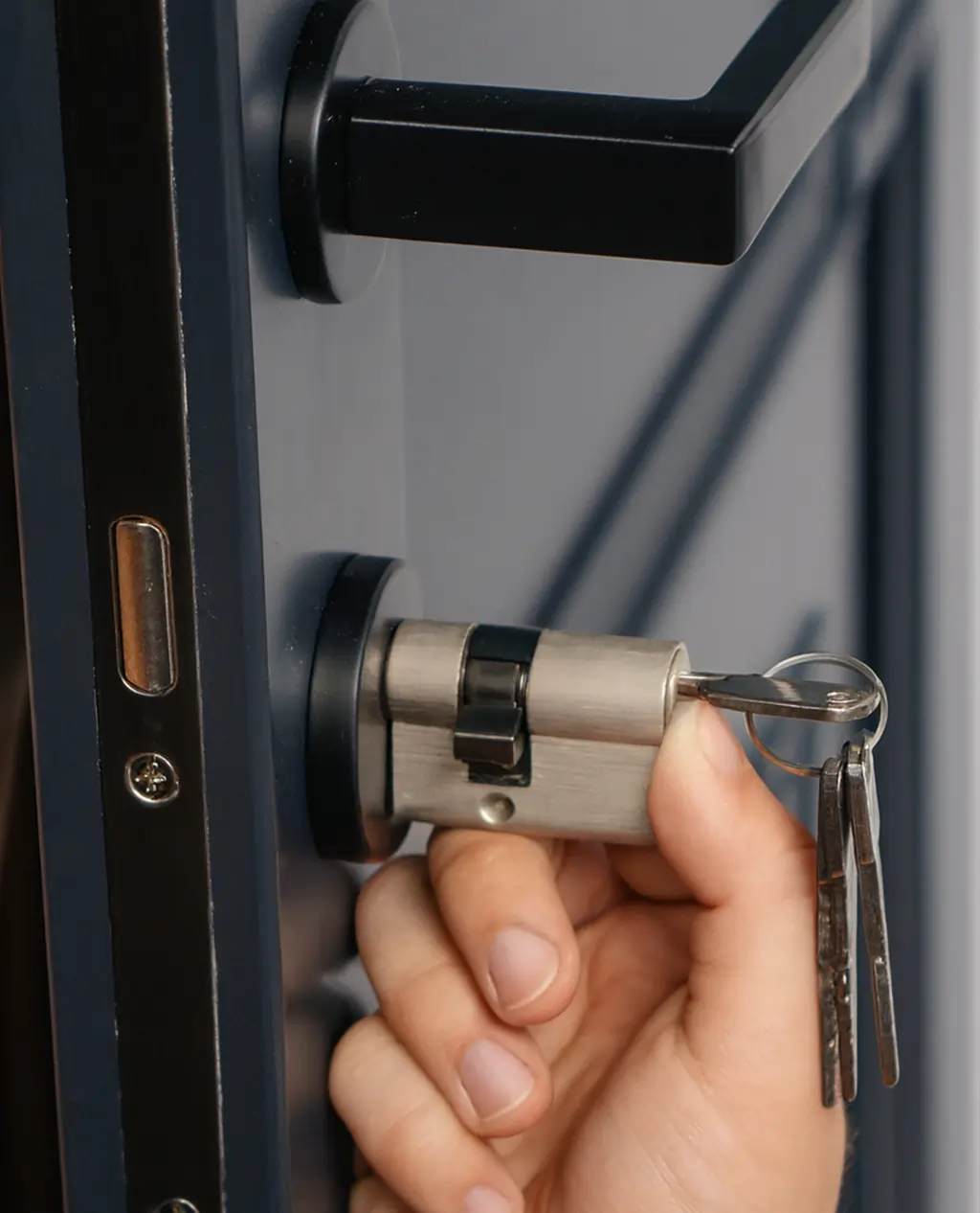 Locksmith rekeying a house door lock in Lithia Springs GA